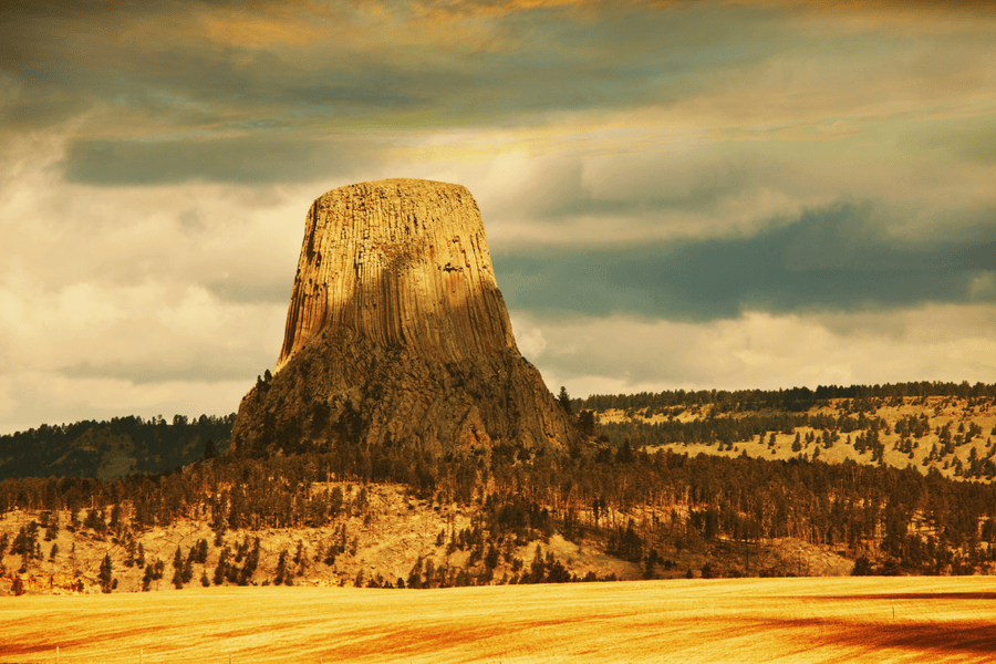 image of tall rock tower surrounded by fields